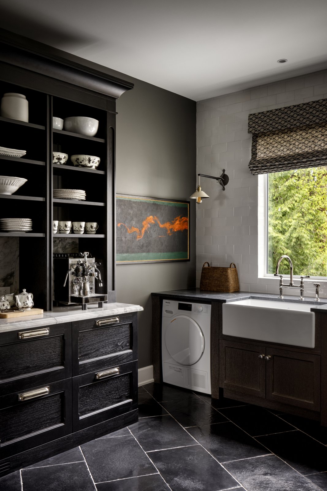 Coffe bar in a laundry room with washer and apron sink.