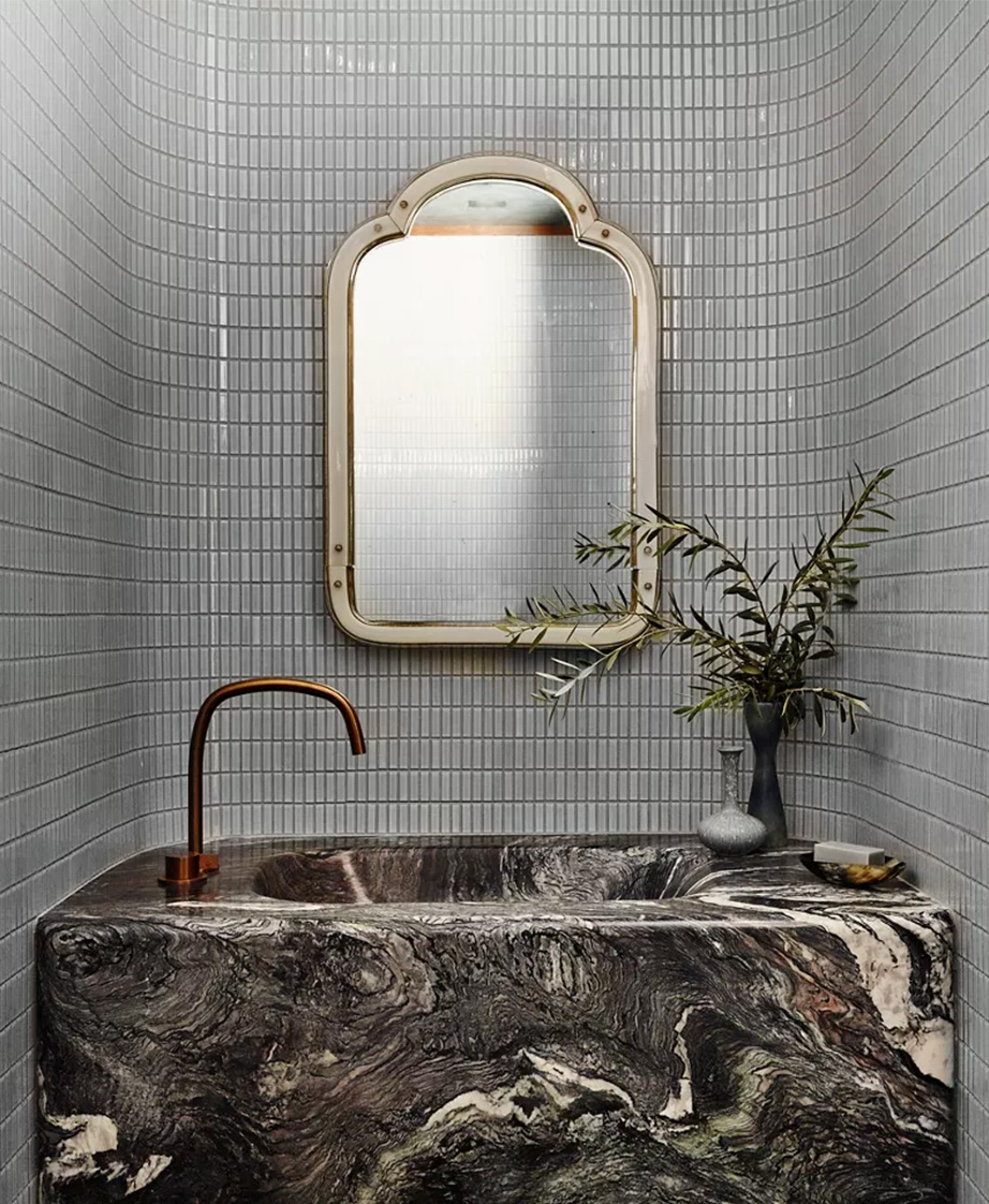Ann Sacks small, grey, rectangle tile bathroom wall with decorative mirror.