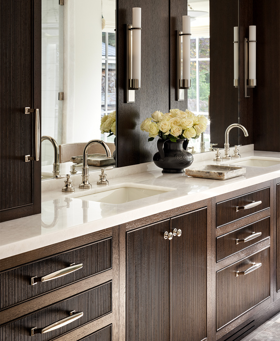 Double bathroom vanity with textured wood cabinetry.